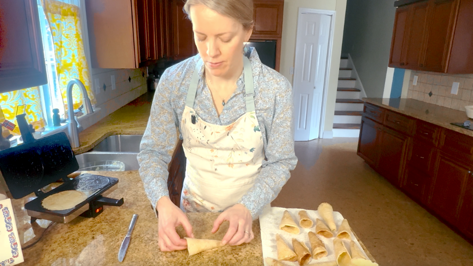 Image of woman rolling krumkake